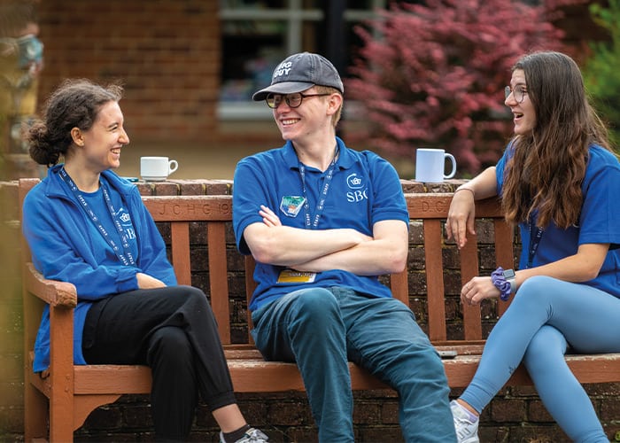 sbc-activity-leaders-smiling-talking-on-bench