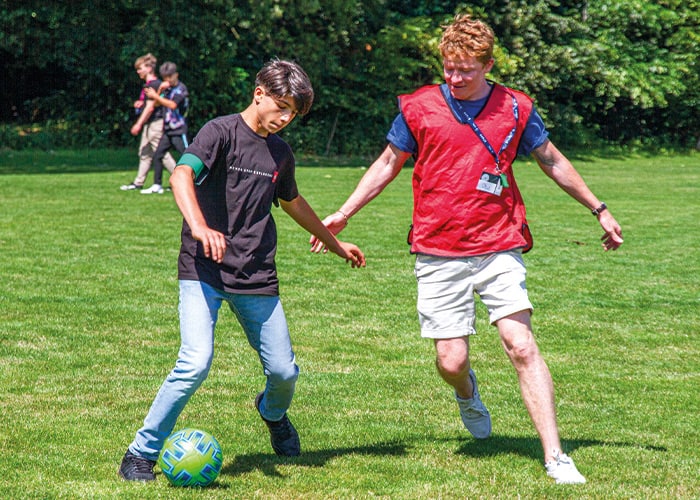 SBC-student-playing-football-with-teacher