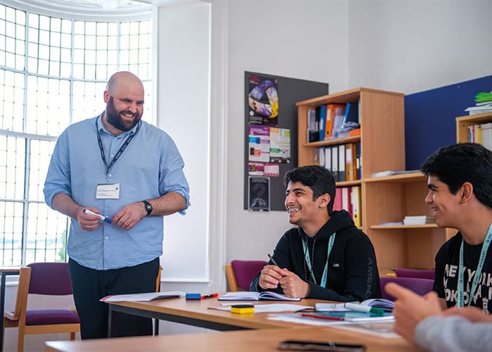 sbc-tutor-and-students-smiling-in-class