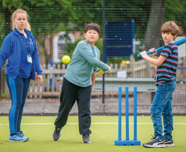 activity-leader-two-students-playing-cricket.