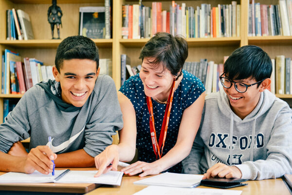 students smiling with a teacher lowres