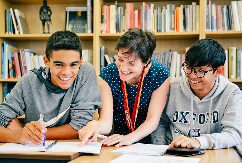 students smiling with a teacher lowres