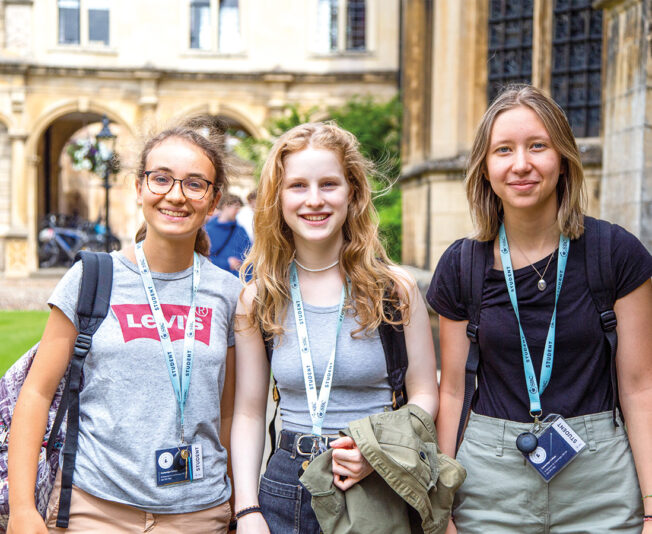 three-students-outside-on-a-trip-smiling