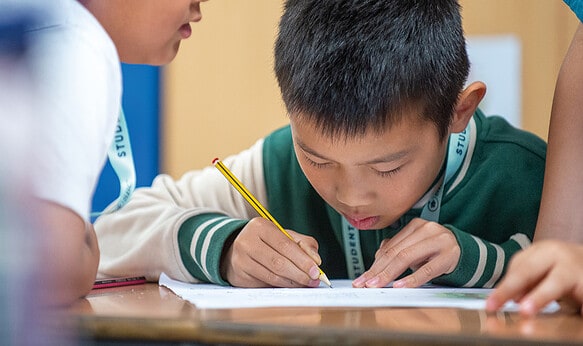 young-sbc-student-working-in-class