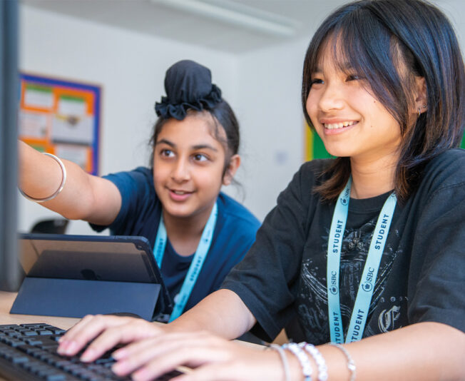 two-females-smiling-studying-at-summer-school.