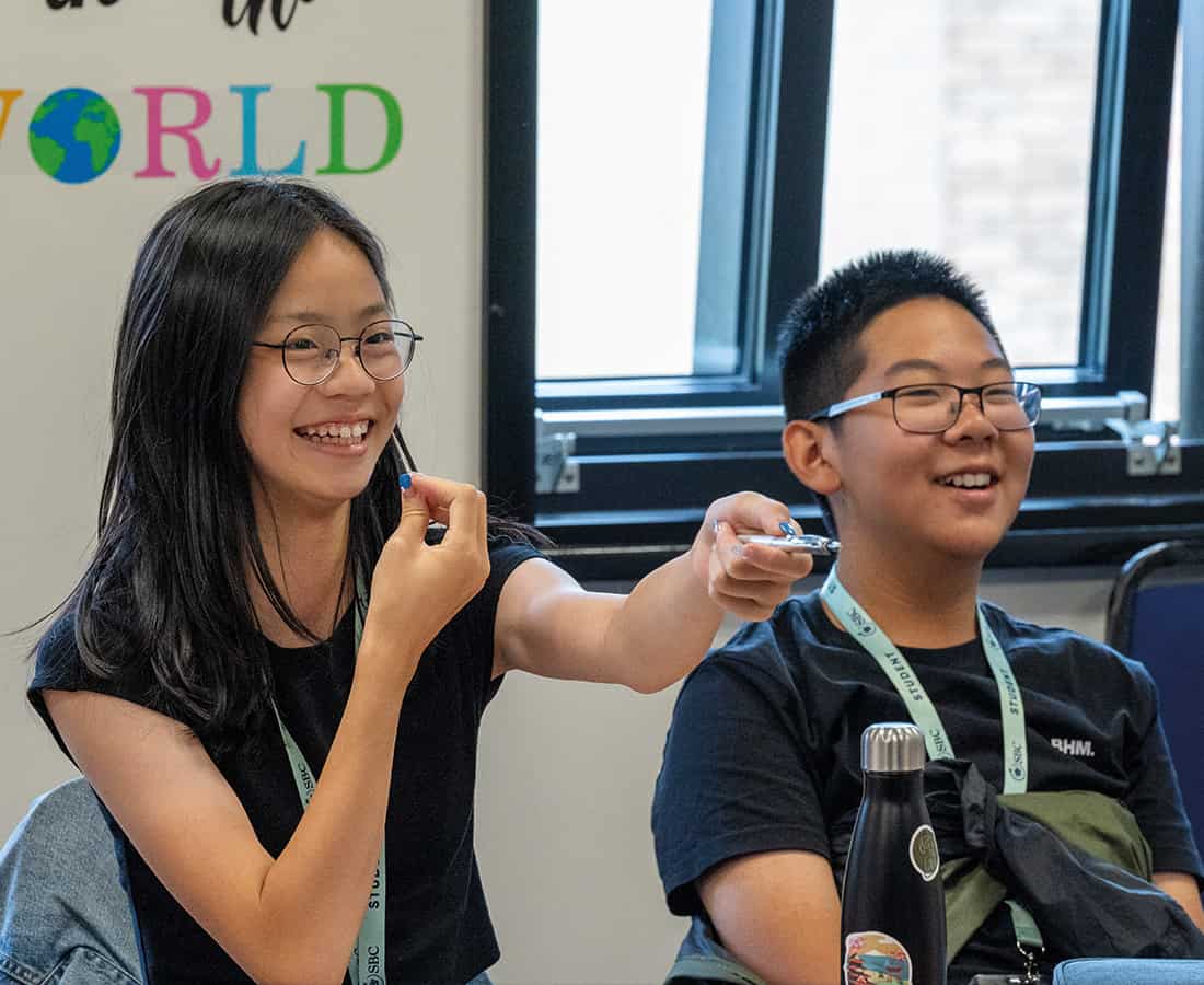 Female-and-male-student-laughing-in-class-at-canford-summer-school