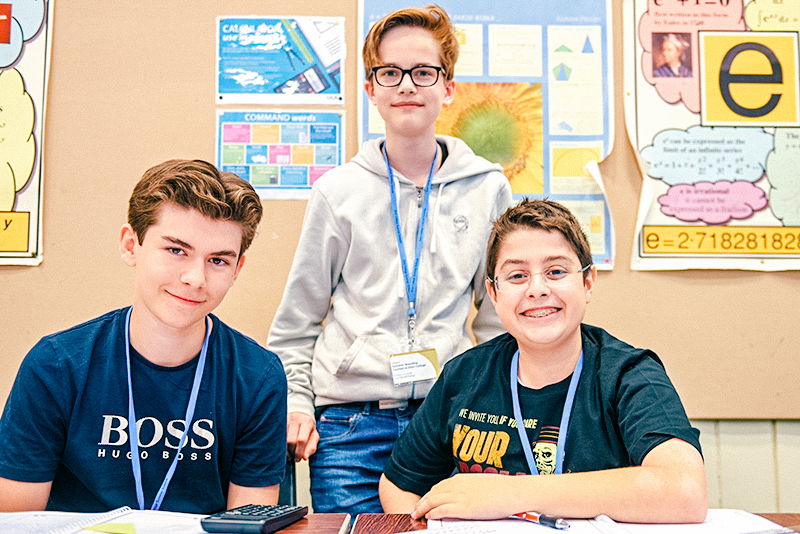 three male students smiling