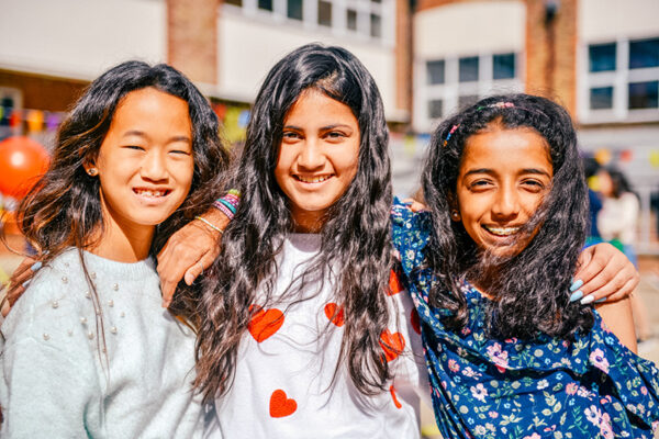 female students with their arms around each other outside lowres