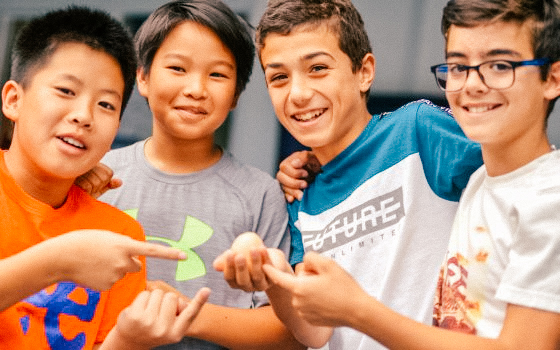 group of male students pointing at something