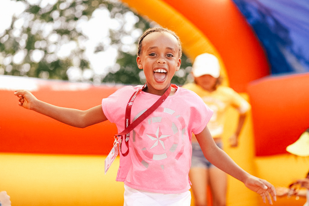 sbc oxford student bouncing outside on bouncy castle