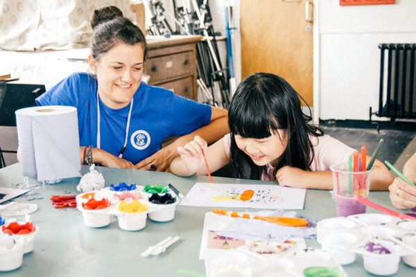 sbc staff member and young student painting lowres