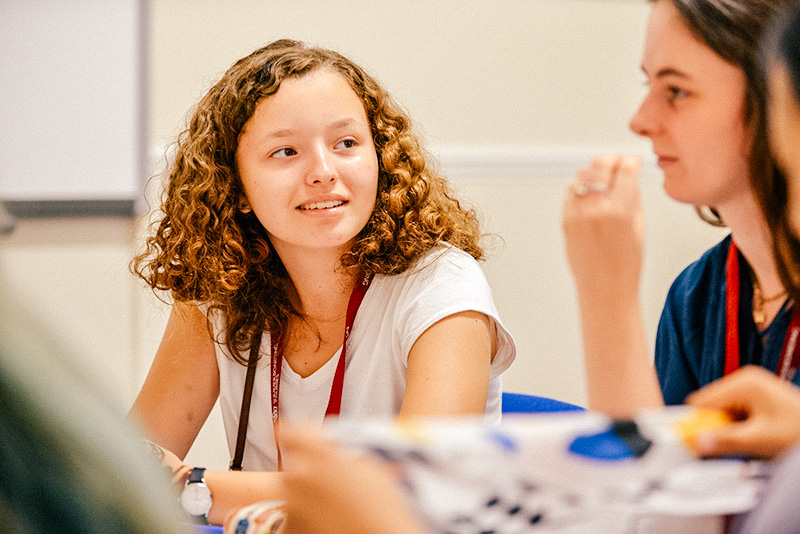 Smiling students in class together