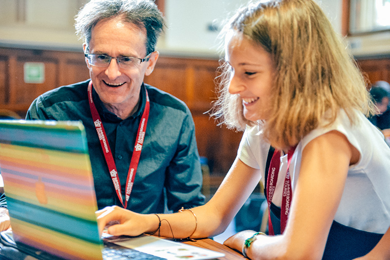 student and teacher looking at computer oxford college lowres