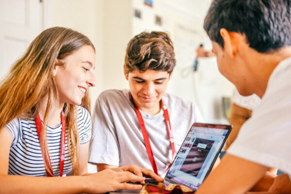 students in class together looking at computer