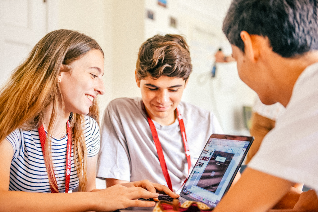 students in class together looking at computer