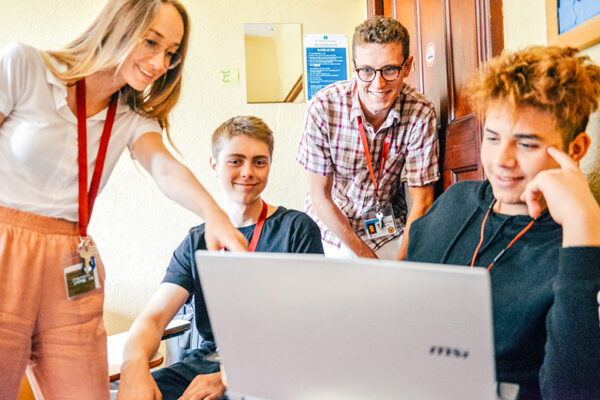 students looking at a laptop in class lowres