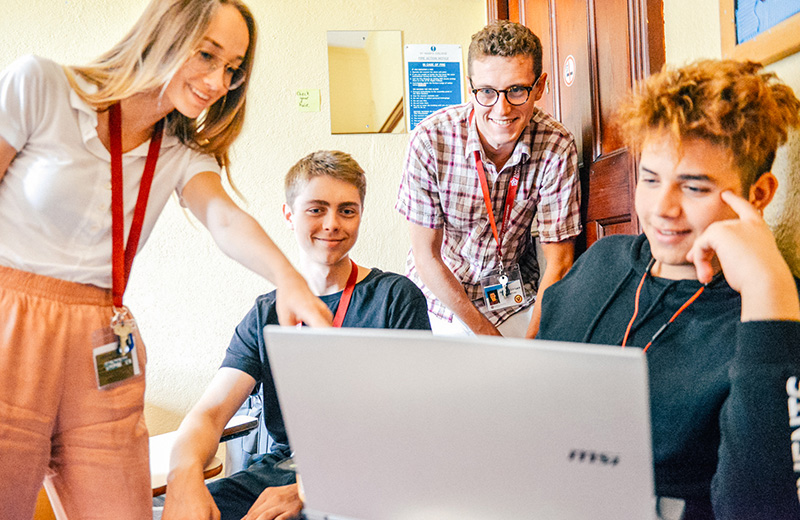students looking at a laptop in class lowres