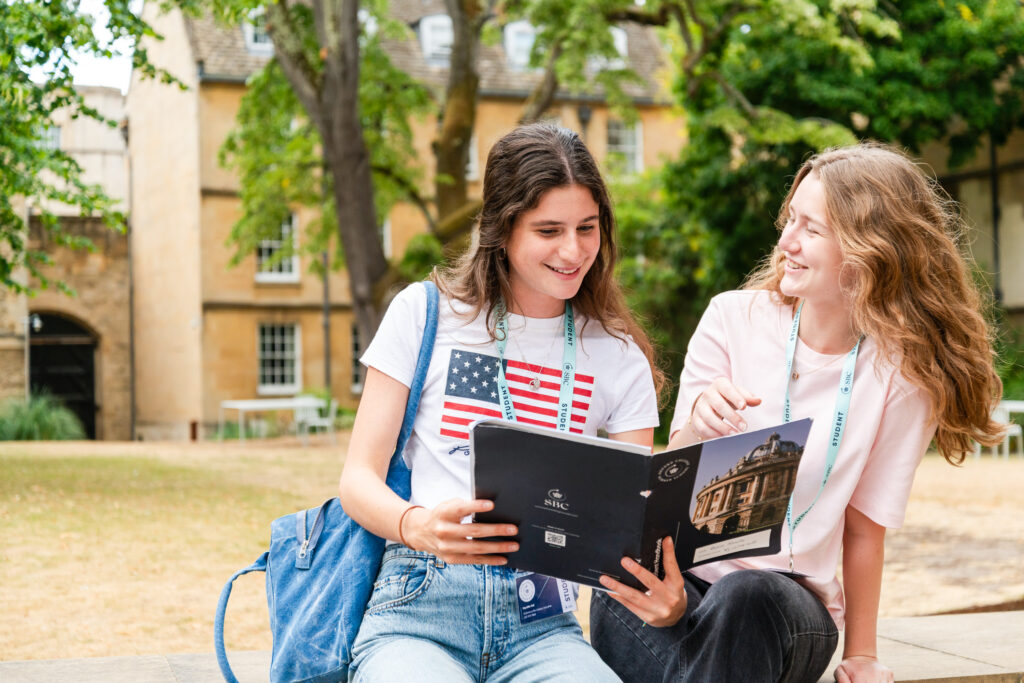 Youth girls enjoying summer boarding courses outdoors in a university campus.