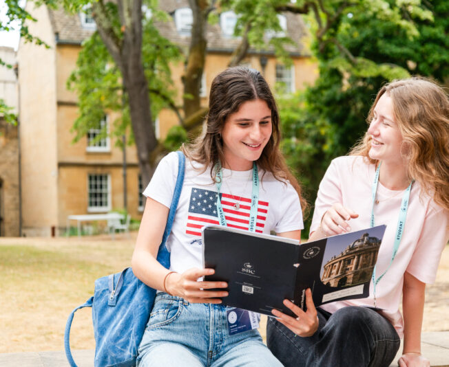 Youth girls enjoying summer boarding courses outdoors in a university campus.