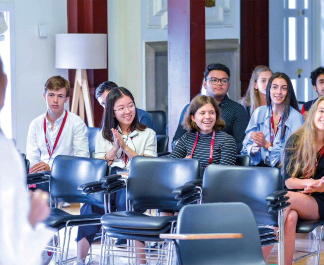 students-clapping-laughing-summer-school-assembly