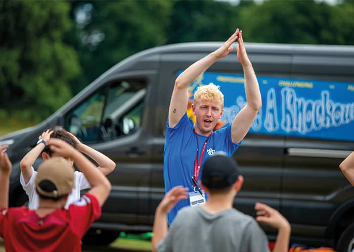 camp-leader-leading-activity-summer-school