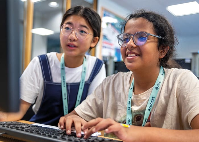 students-enjoying-computer-course-at-summer-school