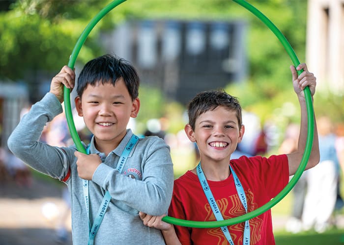 small-two-students-holding-hula-hoop-smiling-sbc