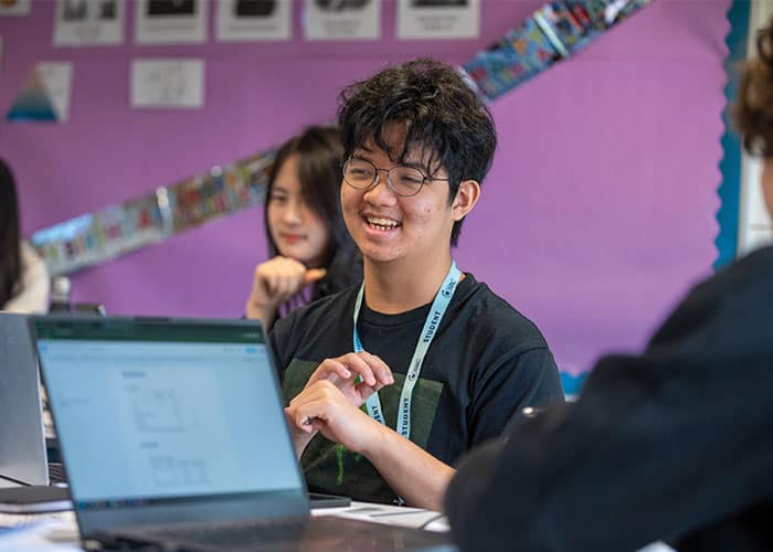 Cambridge summer school student in lesson laughing