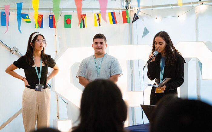 Three students giving a Time to Shine presentation in their class at Oxford College