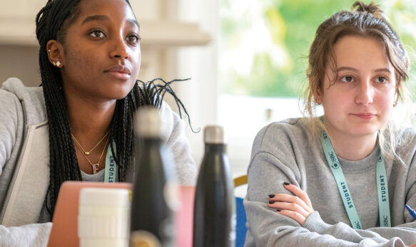 Two female students sat and listening in an Oxford College academic class