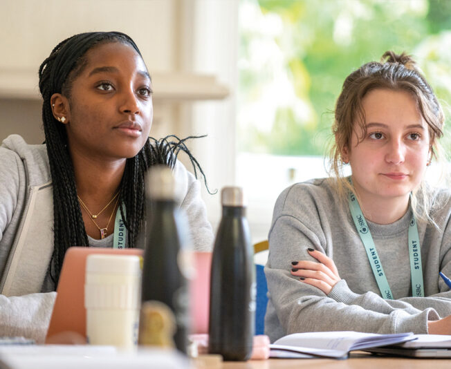 Two female students sat and listening in an Oxford College academic class