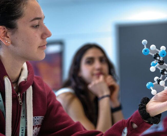 Female-student-looking-at-molecules-in-summer-school-UK