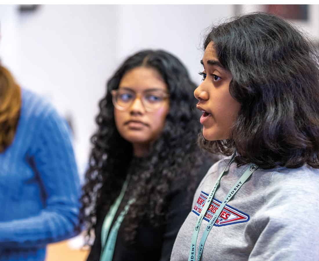 Female student speaking in group at summer school