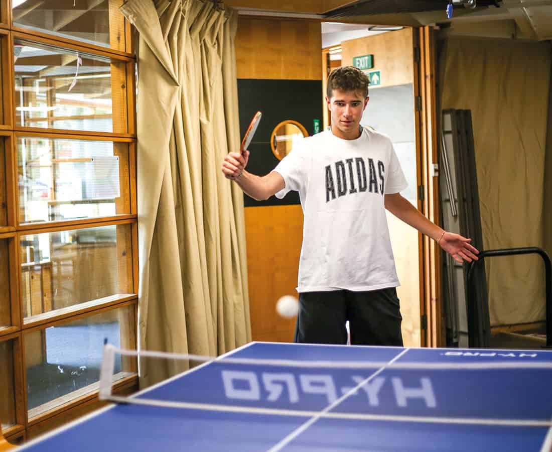Male student playing ping pong