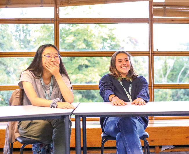 SBC-cambridge-female-students-smiling-in-class.