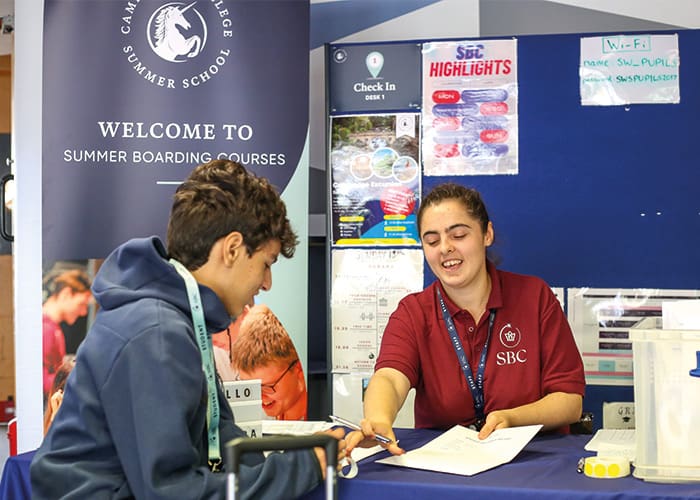 SBC staff pointing to students paper uk