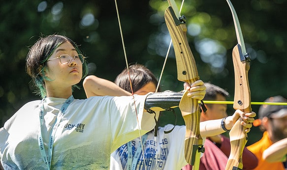 Students at SBC Canford summer school carrying out archery sessions