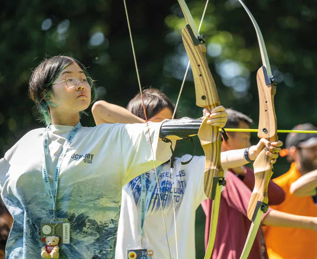 Students at SBC Canford summer school carrying out archery sessions