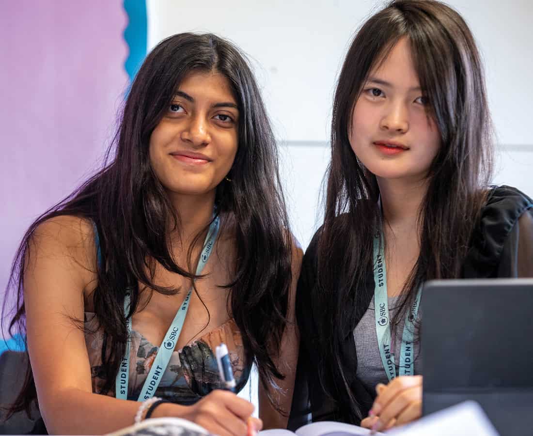 Summer-school-students-smiling-with-laptop.