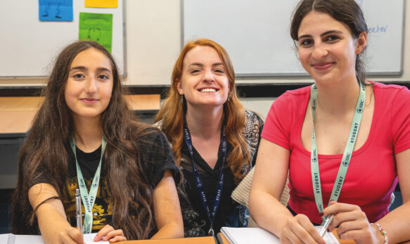 Happy students in the classroom at SBC Canford all smiling and happy to be in the class together