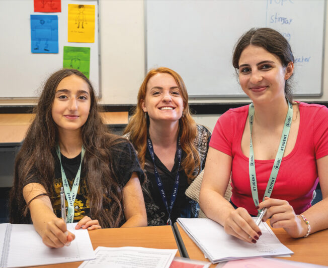 Happy students in the classroom at SBC Canford all smiling and happy to be in the class together