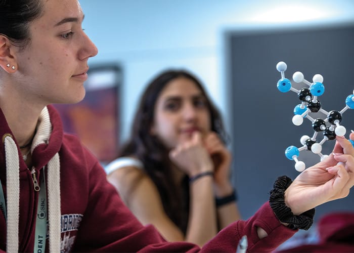 female-student-looking-at-molecules-in-summer-camp-lesson-uk