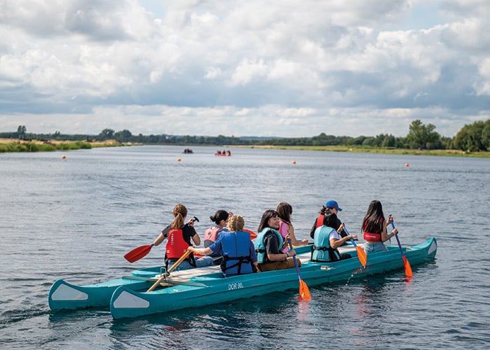 group-of-students-rowing-on-lake