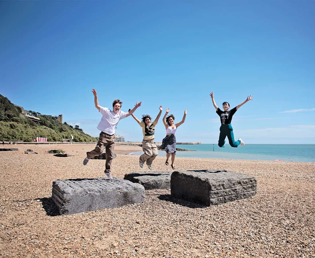 students-on-beach-earlscliff-uk