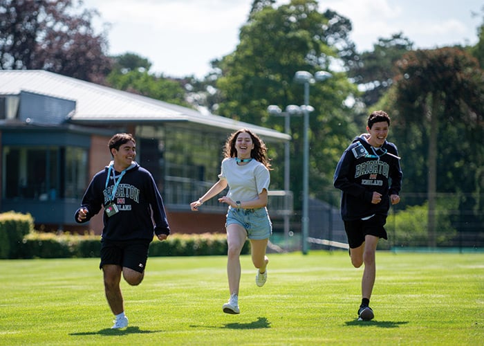 three-headington-students-running-on-grass