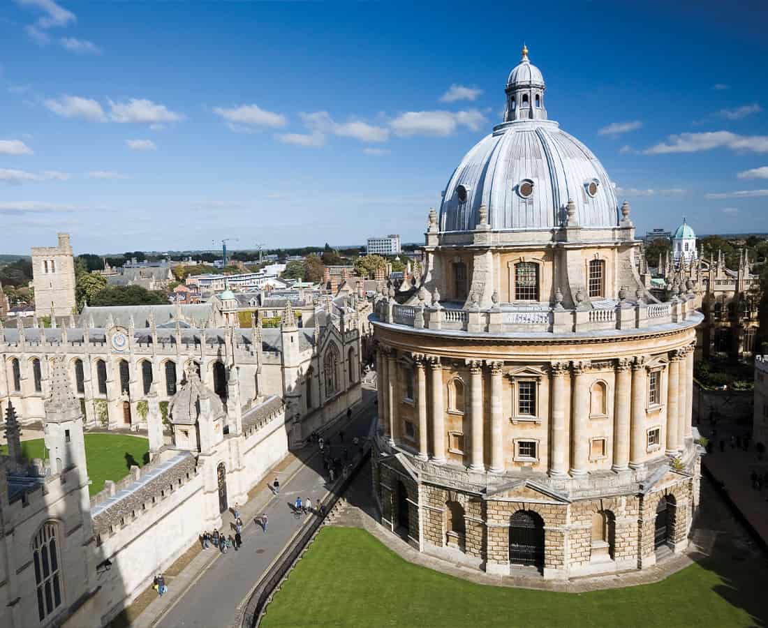 A view of Oxford Radcliffe building with bright blue skies and other buildings surroning it