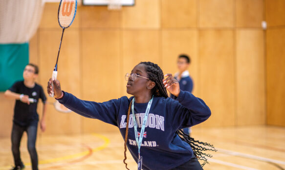 Female-Student-Playing-Badminton-in-a-sportshall-at-SBC-Eton-College-Summer-School