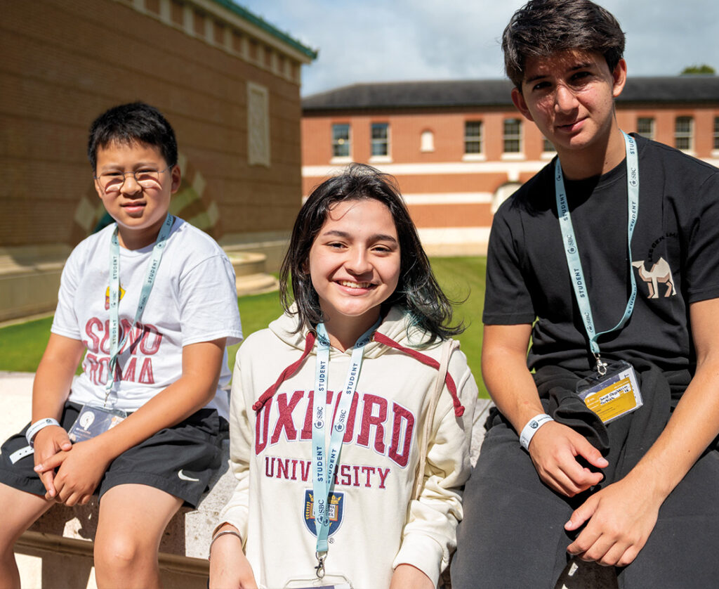 Female-and-two-male-students-outside-on-a-sunny-day-at-SBC-at-Eton-College-Summer-School