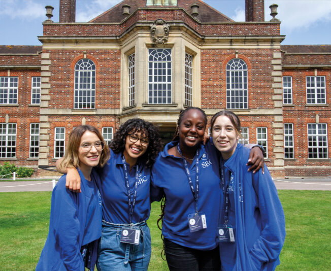 Four female staff members of Summer Boarding Courses stood outside Headington Oxford building