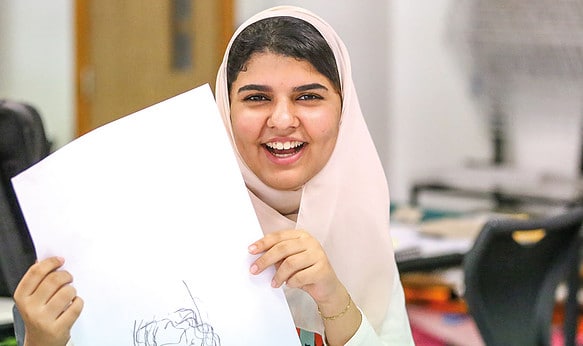 Happy-sbc-student-holding-artwork-at-cambridge-college